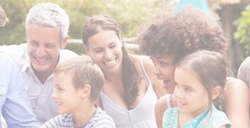 A group of people are smiling at each other.