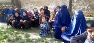 A group of children sitting on the ground.